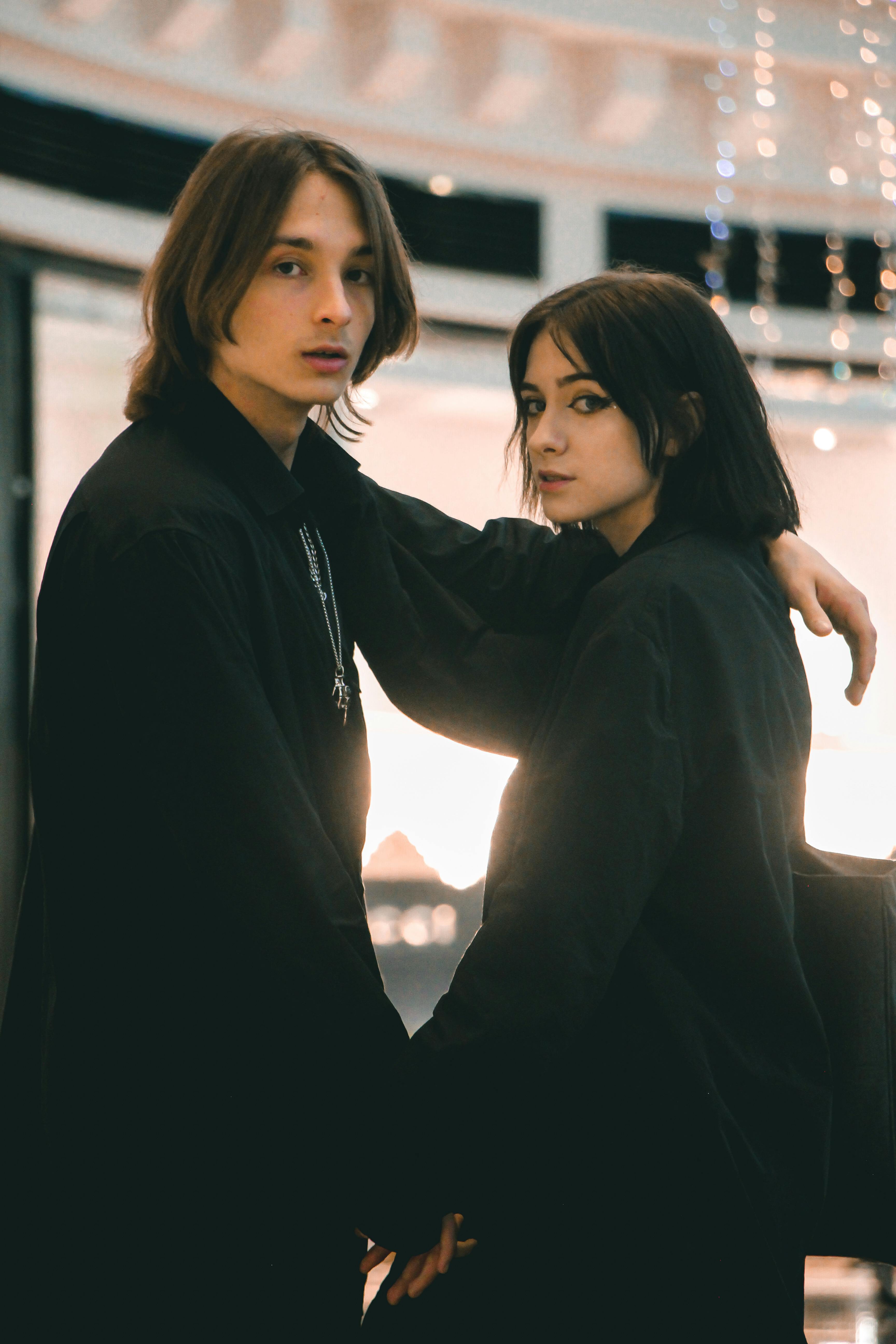 two fashion models posing together in black clothes