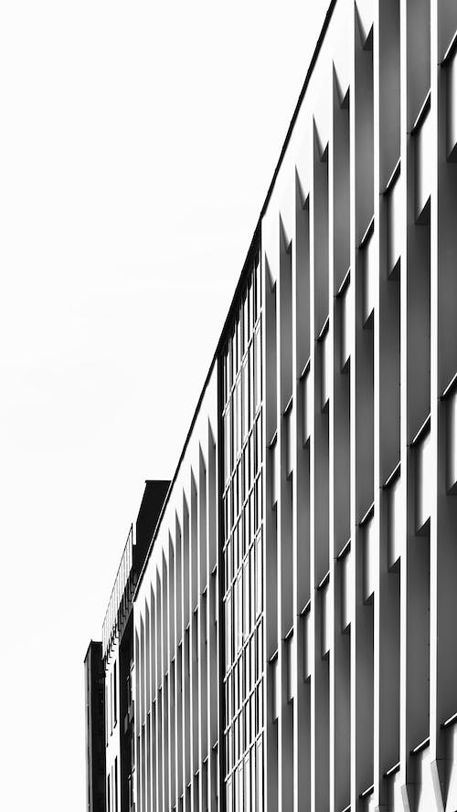 Black and White Photo of a Facade of a Modern Building 