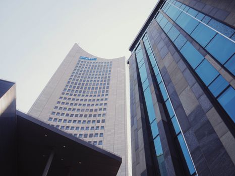 Modern skyscrapers from a low angle with reflective glass facades in daylight.