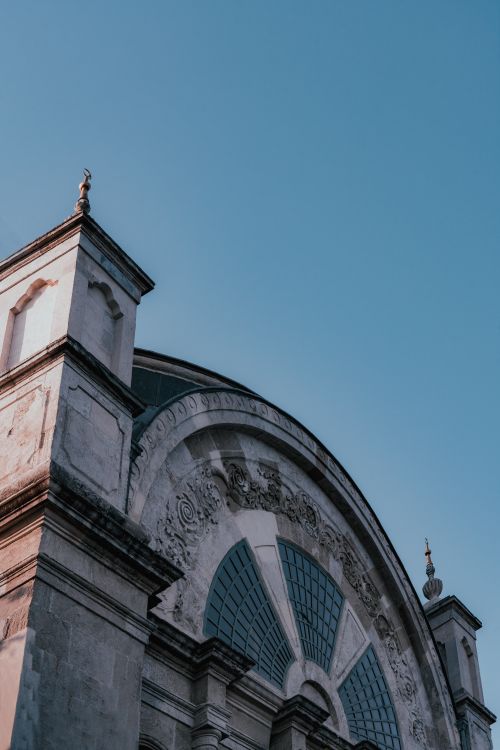Free A low angle view of an ornamented mosque wall in Istanbul, Turkey, showcasing intricate architectural details. Stock Photo