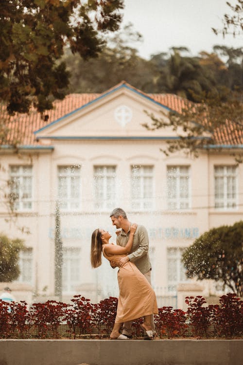 Free Romantic Couple Embracing by Fountain Stock Photo