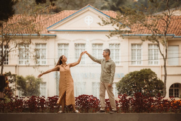 A Couple Dancing Near A Fountain