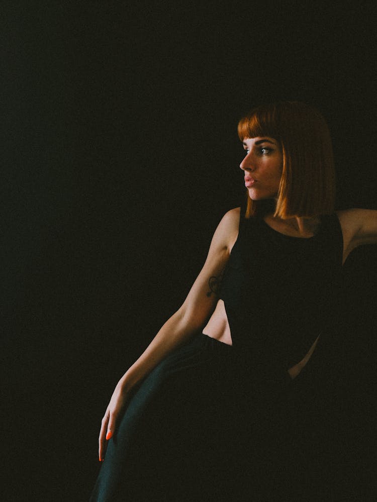 Woman In Black Tank Top Looking Over Shoulder