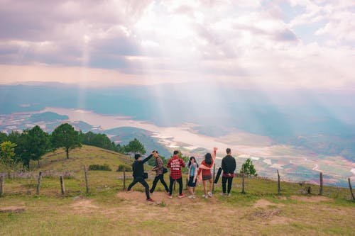 Group Of People Standing Near Fence