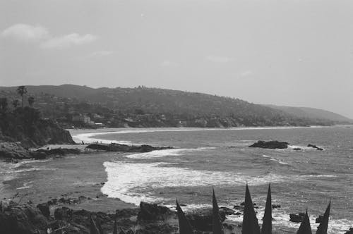 Grayscale Photo of Sea Waves Crashing Shore