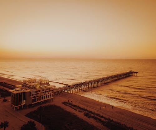 Wooden Boardwalk on Sea during Sunset