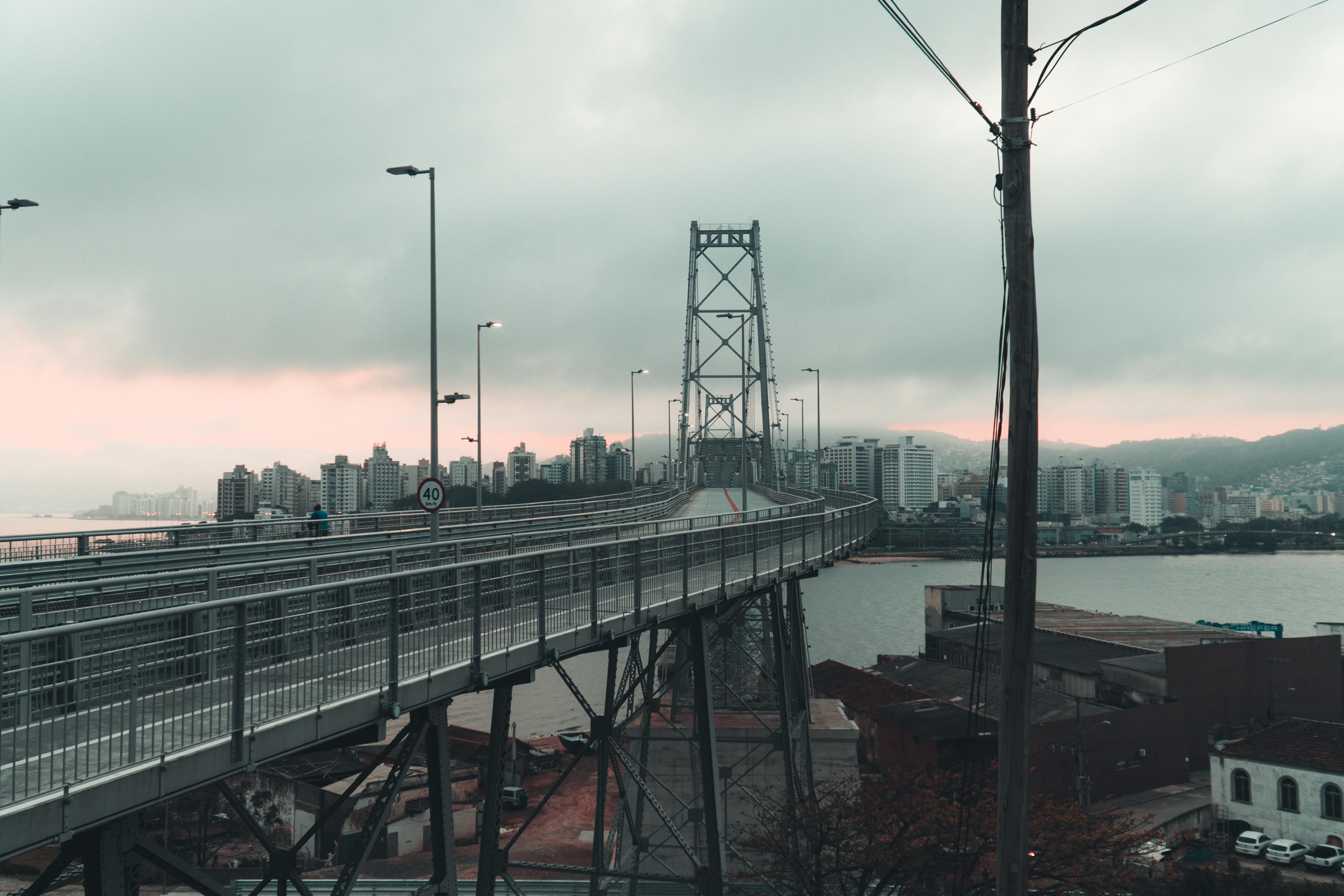 Scenic view of Hercílio Luz Bridge and cityscape of Florianópolis at dusk.