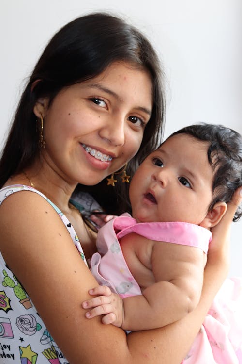 A Girl Carrying a Baby