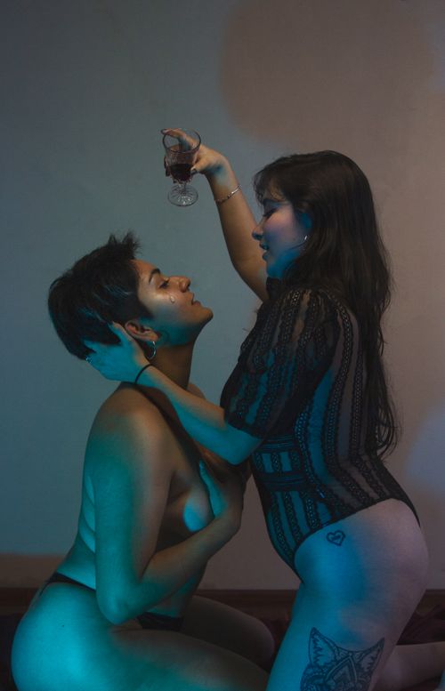Free Two women in an intimate pose expressing affection, indoors setting. Stock Photo