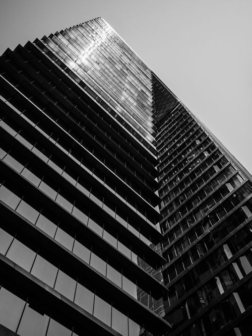 Free A striking black and white image of a modern skyscraper shot from a low angle. Stock Photo