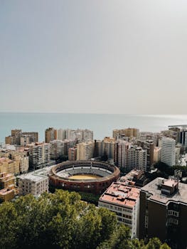 Discover Málaga's vibrant cityscape with its iconic bullring and coastal horizon in view.