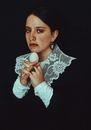 Portrait of a Woman in Lace Collar Holding a White Egg