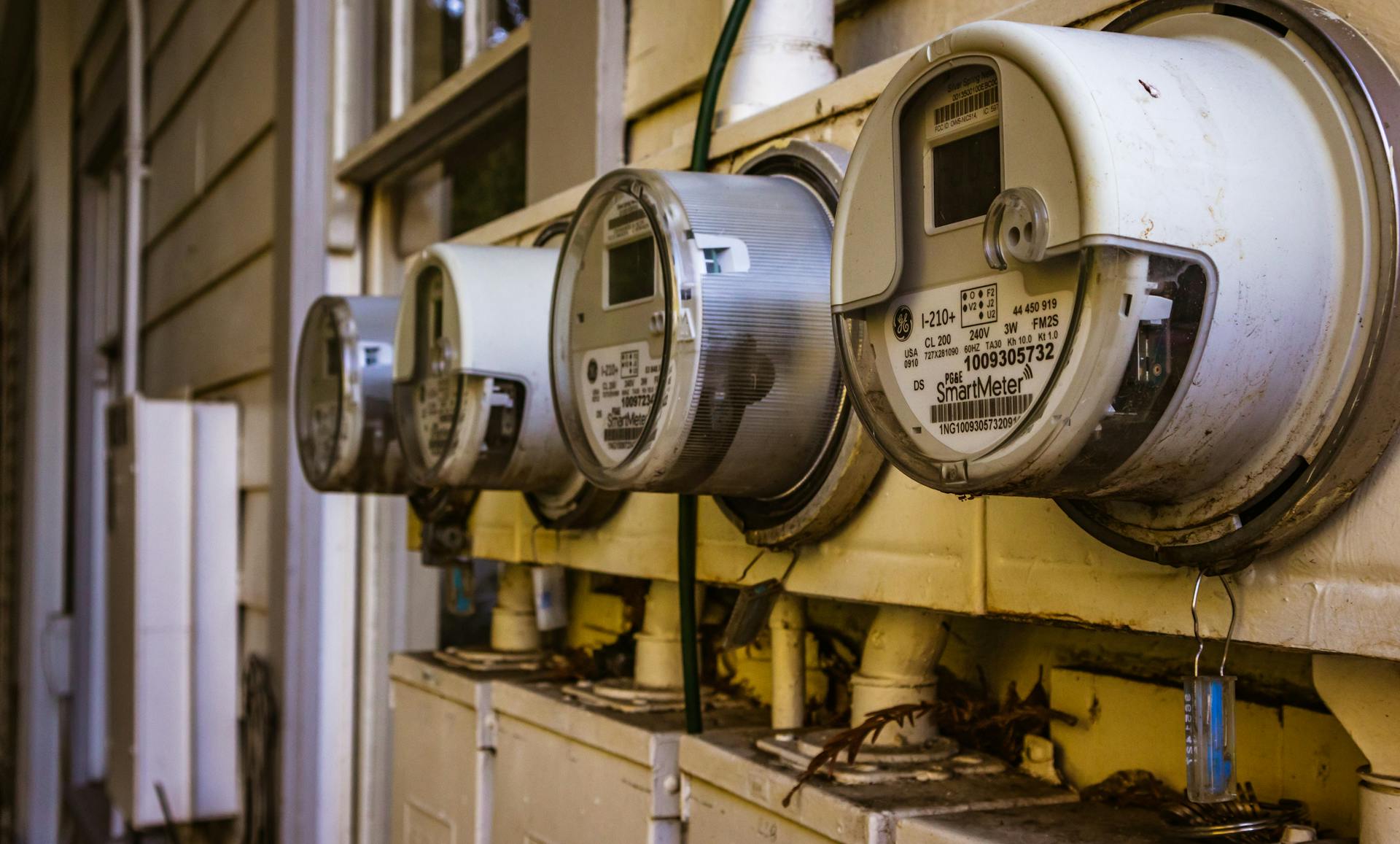 Image of multiple smart electricity meters installed on a residential exterior wall, showing environmental adaptation.