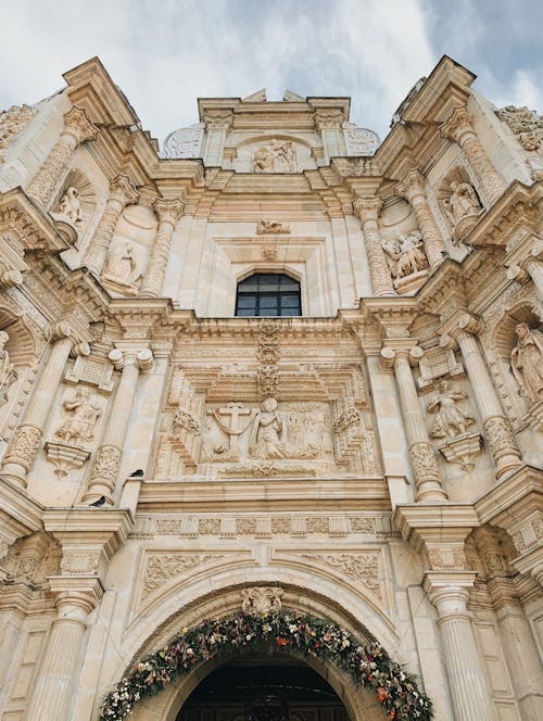 Free Low Angle Shot of a Church Facade with Reliefs Stock Photo