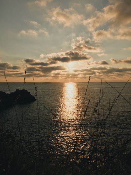 Free Peaceful sunrise over ocean with tranquil reflections in the water. Stock Photo