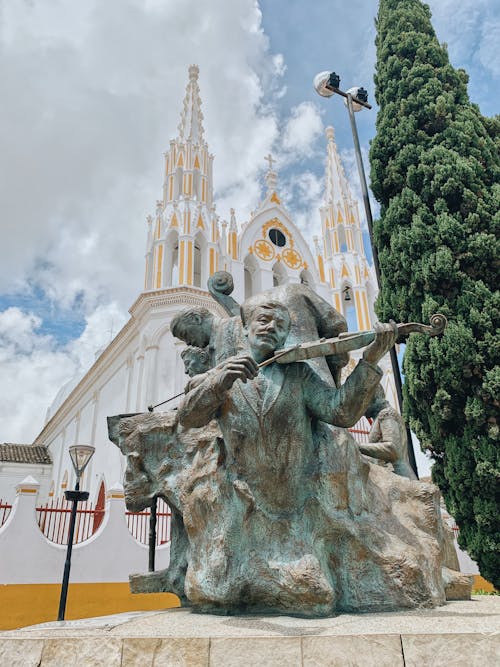 Concrete Statue in Front of a Catholic Church