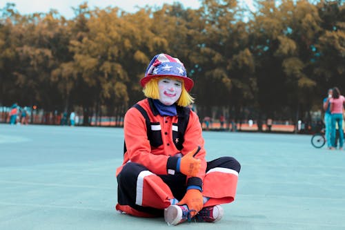 Low-angle of Clown Sitting on Ground
