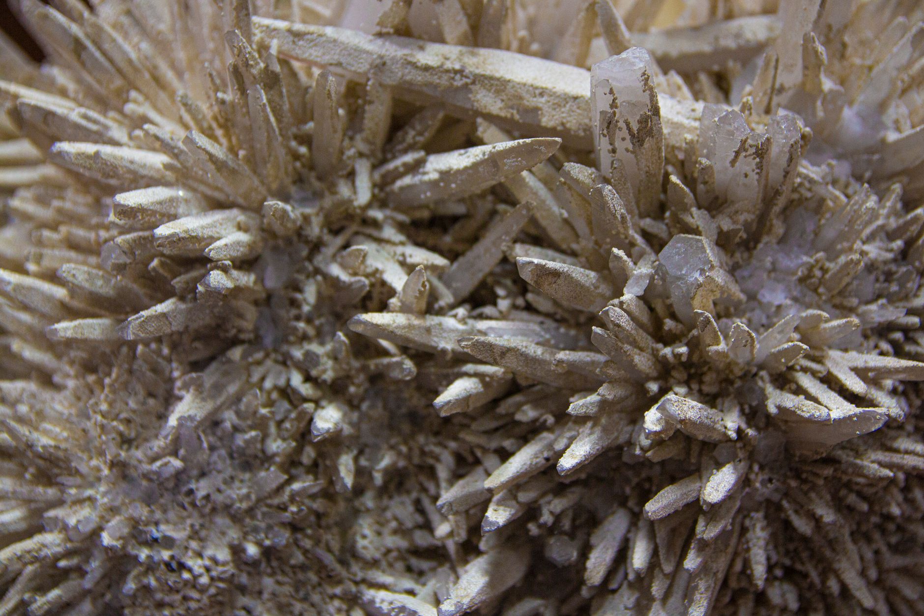 Detailed view of raw crystal formations with intricate structures and earthy tones.