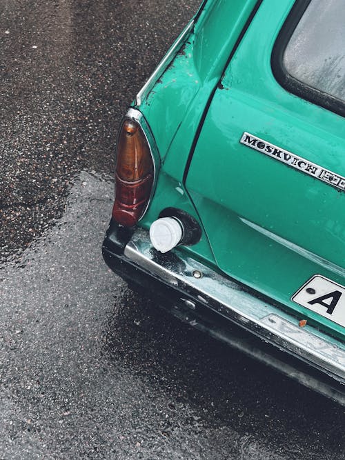 Chrome Bumper of a Green Car