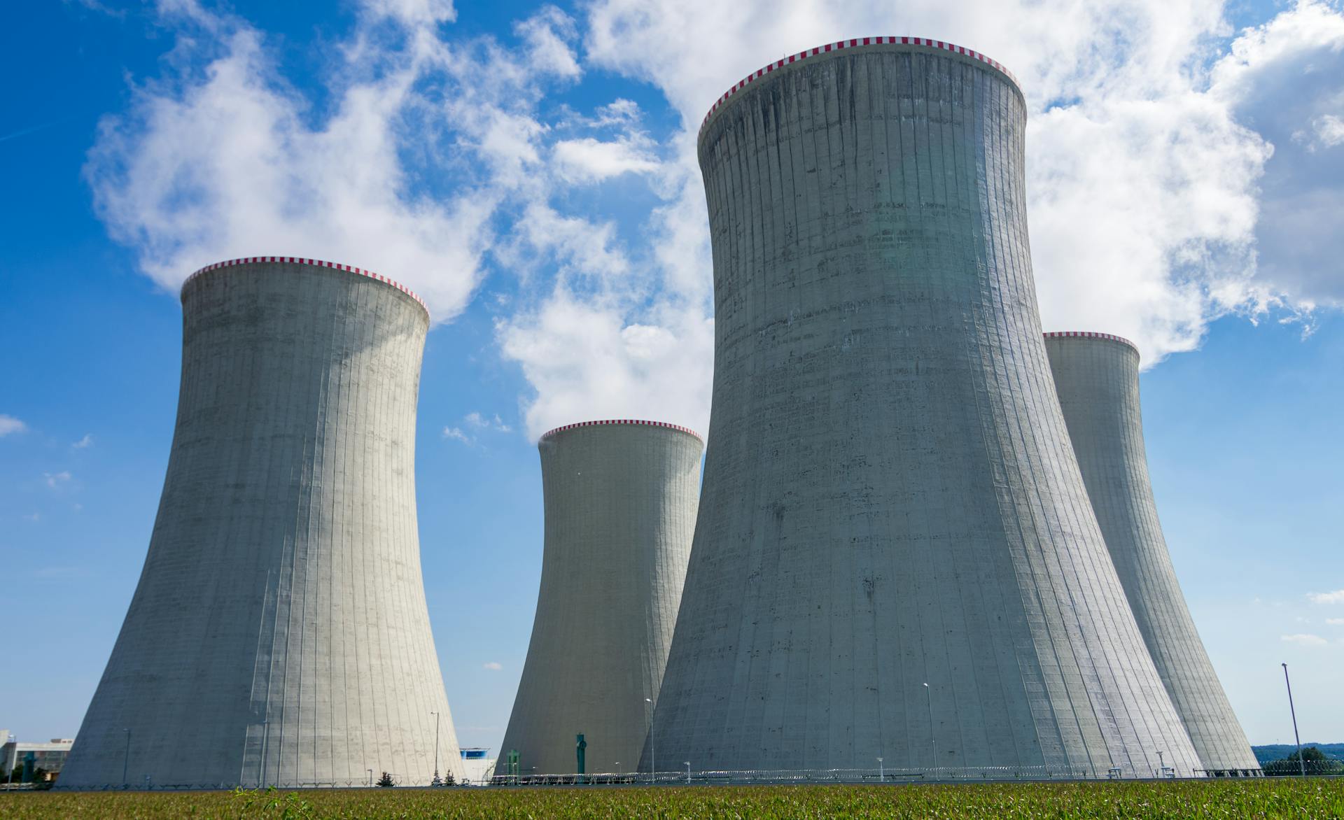 Cooling towers of Dukovany Nuclear Power Plant against a clear blue sky.