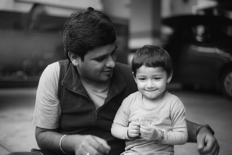 Man With A Child In Grayscale Photography