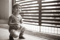 Grayscale Photo of Girl in Long Sleeve Shirt Sitting on Floor