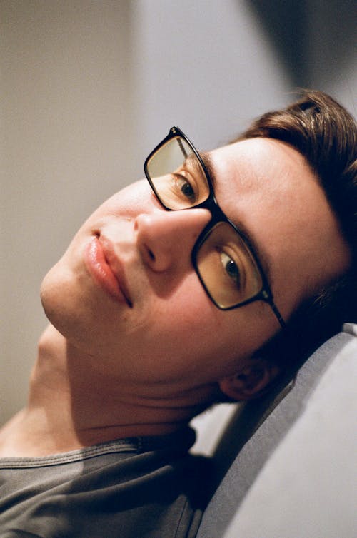 Close-Up Shot of a Man with Black Eyeglasses