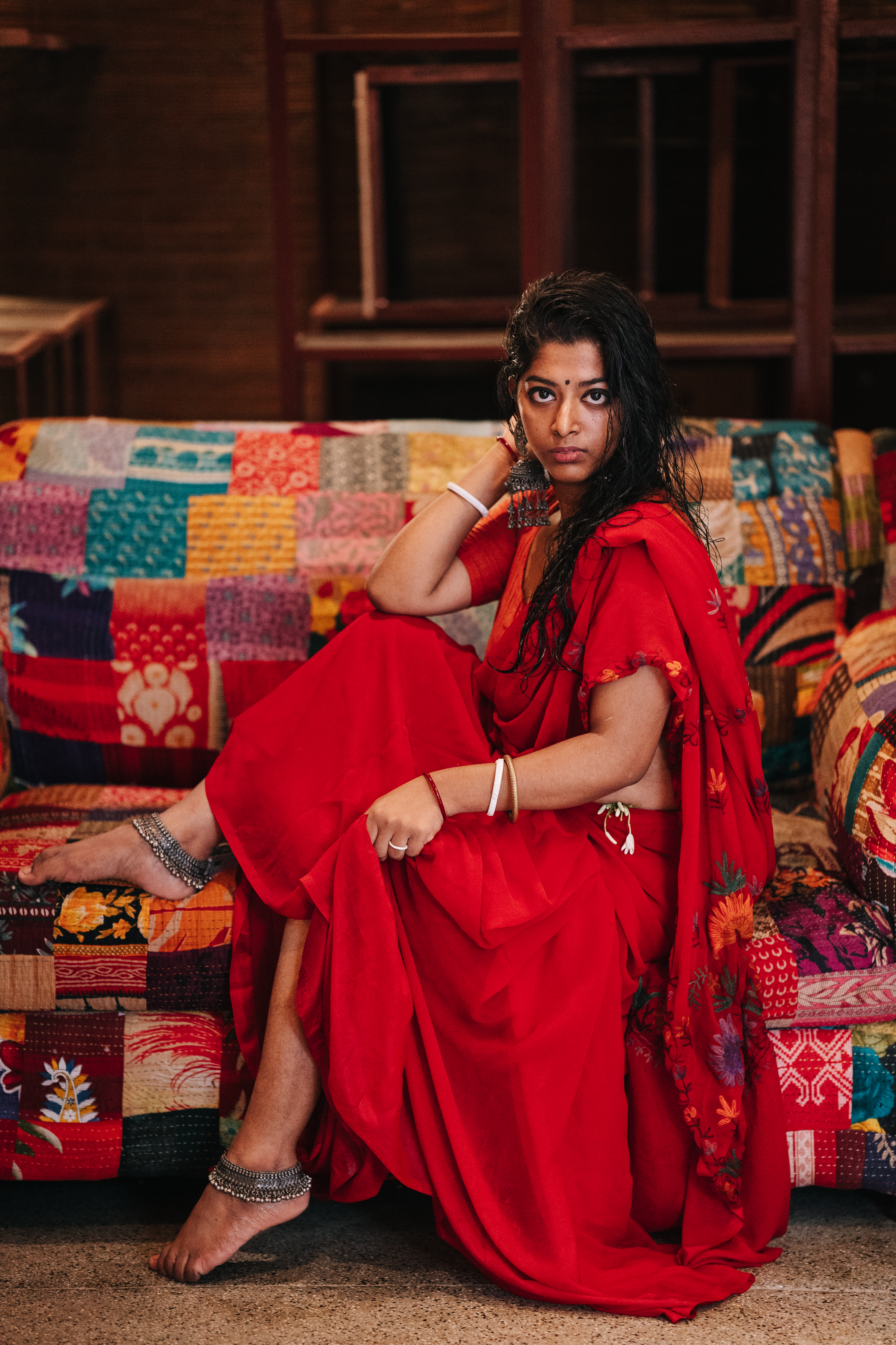 A Woman in Red Dress Sitting on Couch · Free Stock Photo
