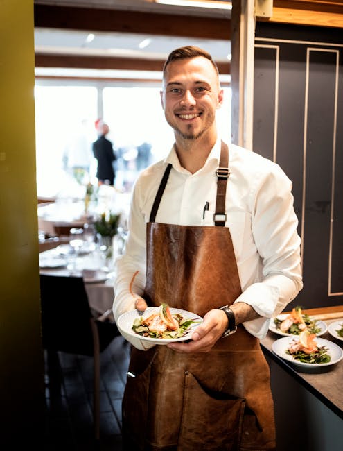 A chef presenting a beautifully plated dish to a client, both smiling and engaged in conversation.