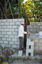 A Man Constructing a Hallow Blacks Wall