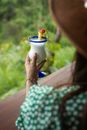 Person Holding White Ceramic Cup With Yellow and Red Bird
