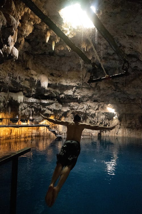 Free A Man Diving on a Underground Lagoon Stock Photo