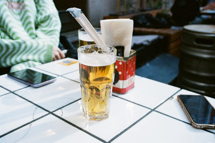 Glass Of Beer On White Table