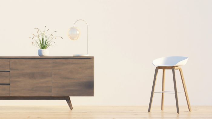Walnut sideboard and stool against a pale wall — photo by dada _design on Pexels