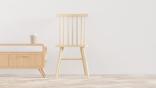 Free Simple and modern wooden chair and cabinet in a minimalist interior. Stock Photo