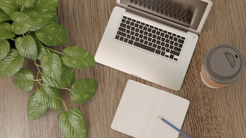 Free High Angle Shot of a Laptop and Notebook Stock Photo