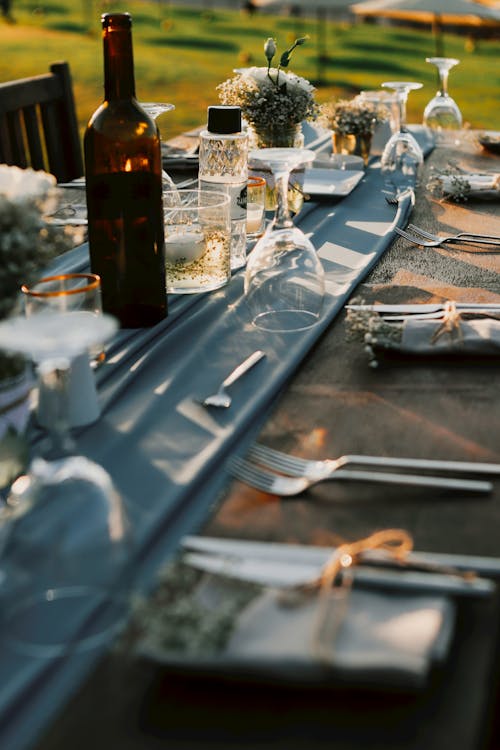 A Wine Bottle on Table with  Formal Setting