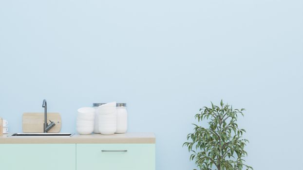 A minimalist kitchen setup featuring a mint colored cabinet, plant, and simple decor.