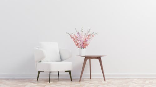 White Armchair Beside the Wooden Side Table