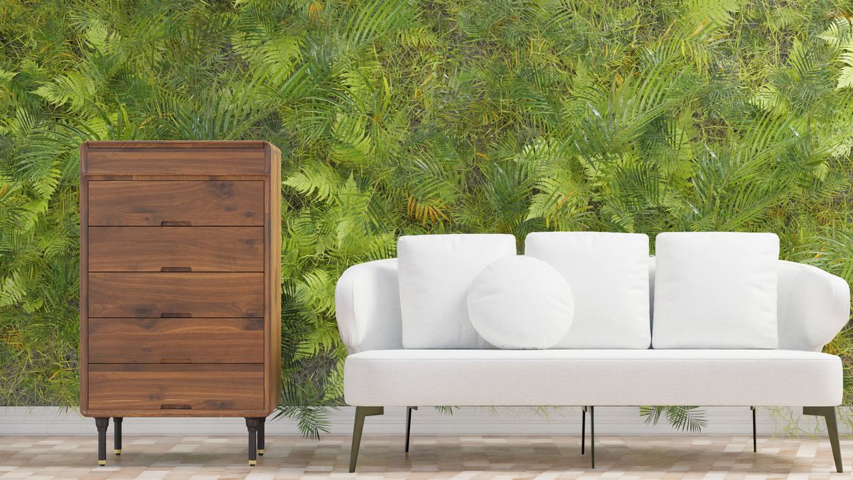 Elegant living room with a white sofa, a wooden drawer unit and a green wall