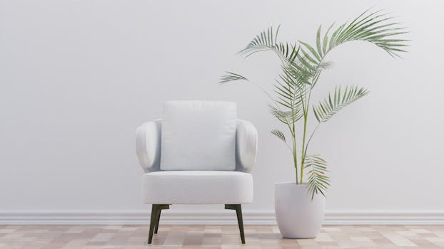 Elegant modern armchair beside a potted plant in a minimalist living space.