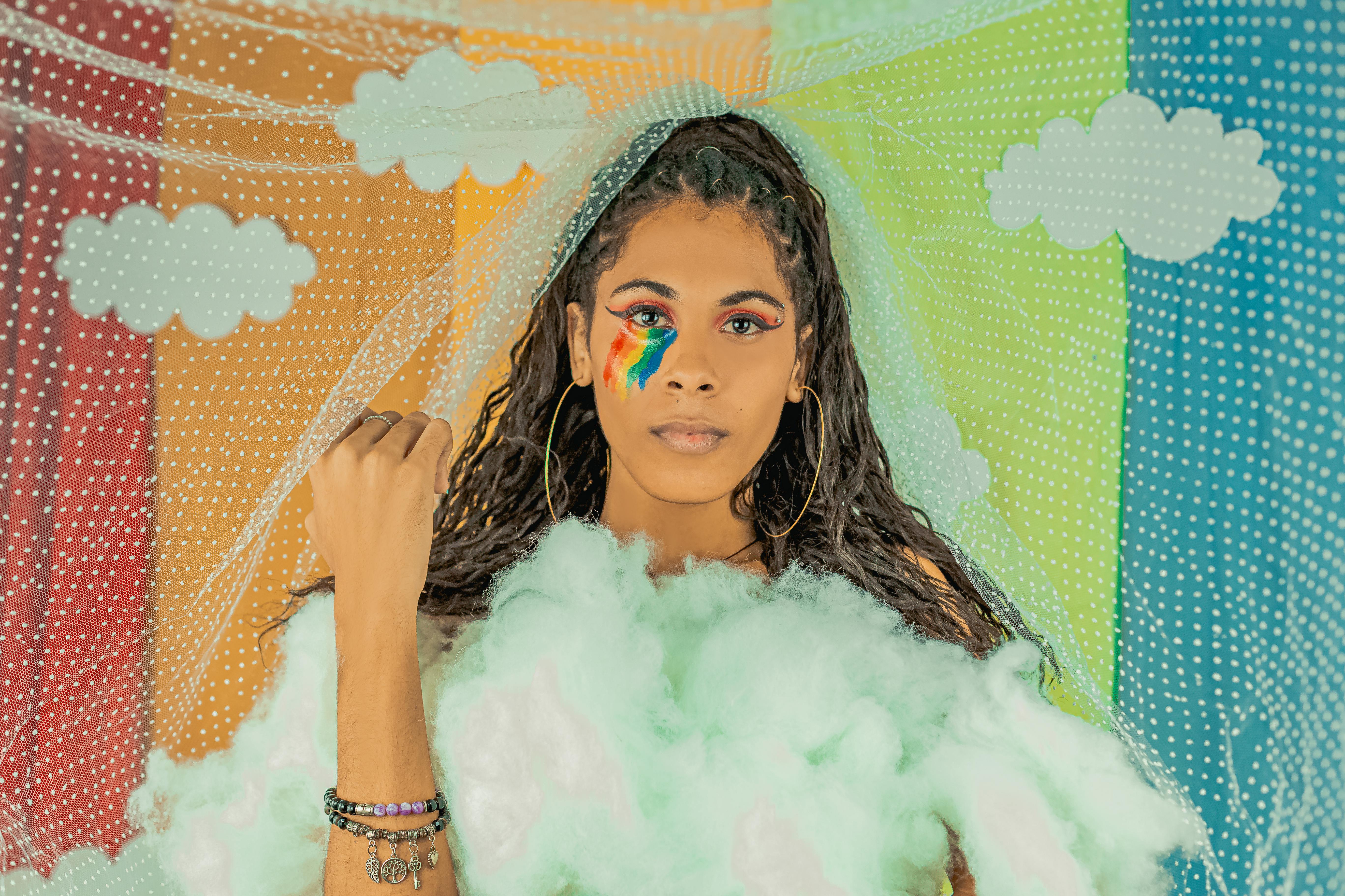 A Woman with Rainbow Face Painting Under her Eye · Free Stock Photo