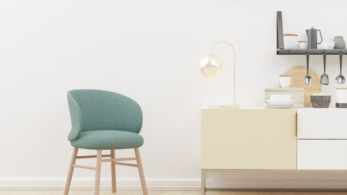 Free Modern minimalist interior featuring a green chair and stylish decor. Perfect for home design themes. Stock Photo