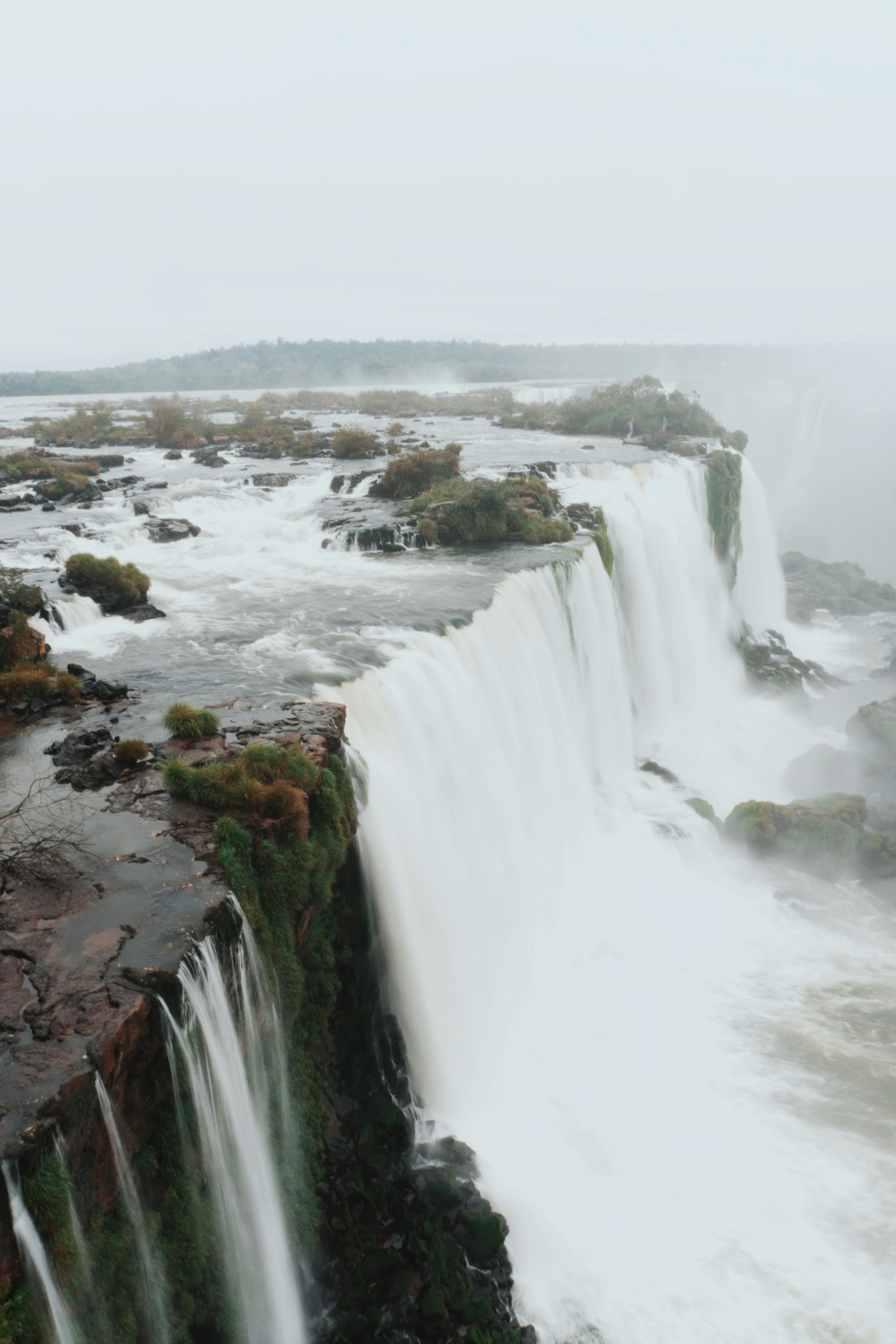 spectacular waterfall on ridge under calm sky