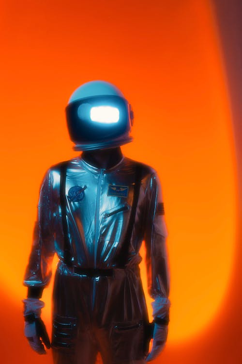 Man in Blue Space Suit and Helmet Against Orange Background · Free ...