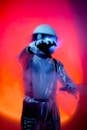 Man in Blue Space Suit and Helmet Against Pink Background