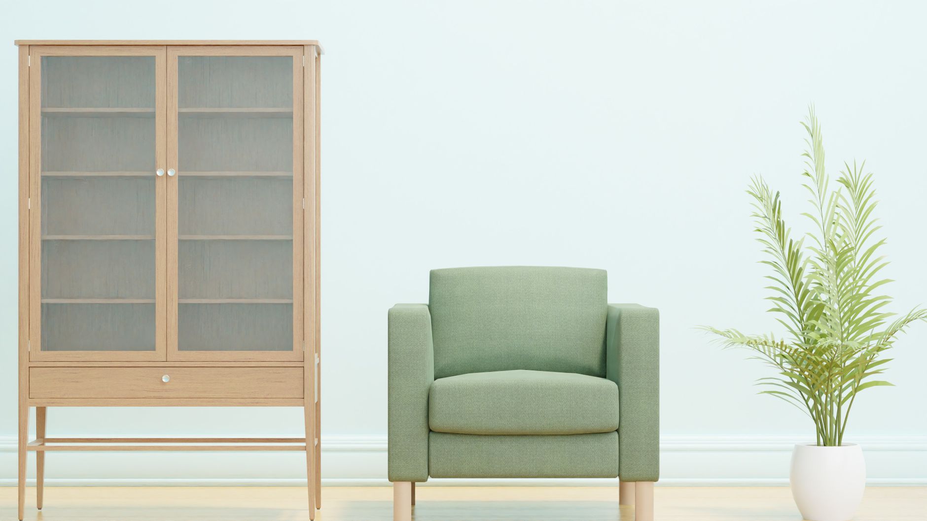 Simple and elegant minimalist interior featuring a green armchair, wooden cabinet, and potted plant.