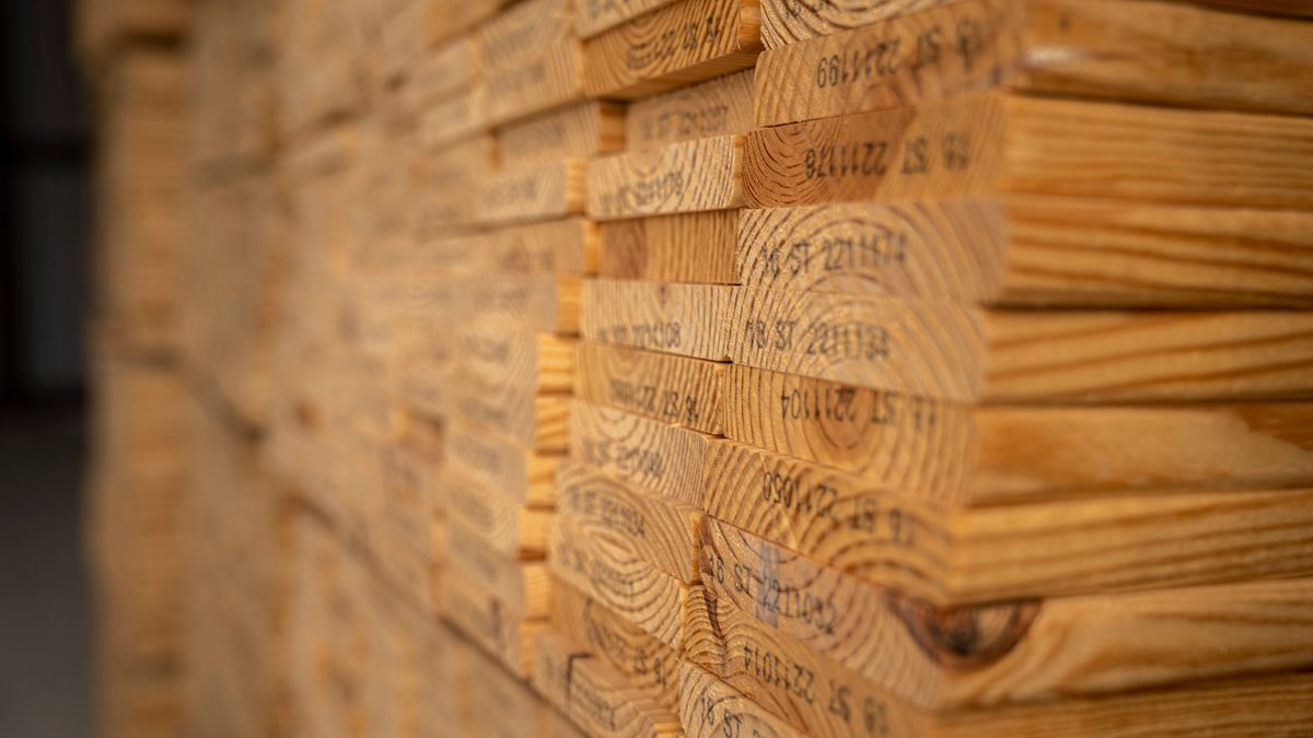 Rough-sawn planks stacked to dry. Hardwood thickness is quoted in quarters: 4/4, 5/4, 8/4.