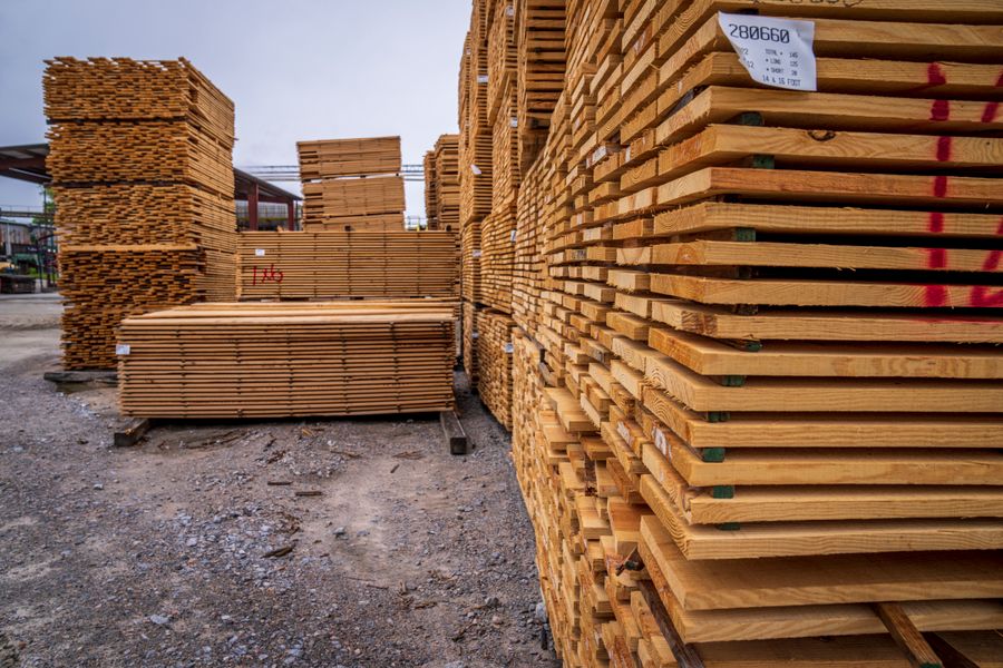 Tall stacks of wooden planks air-drying in a lumber yard