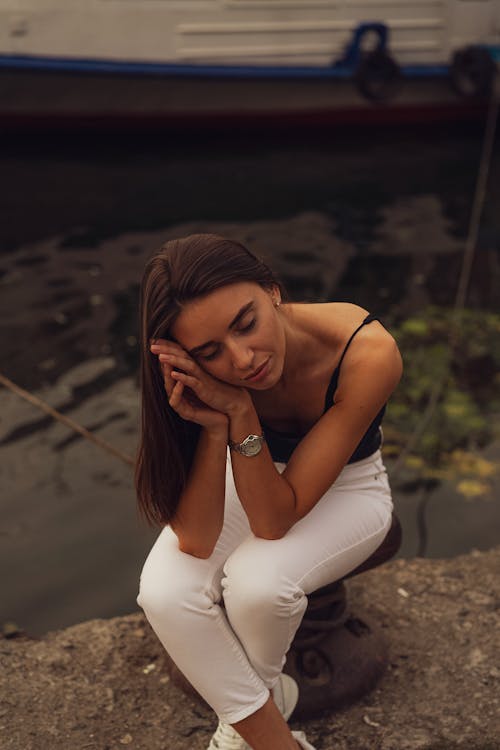 Free Woman Sitting by Water Stock Photo
